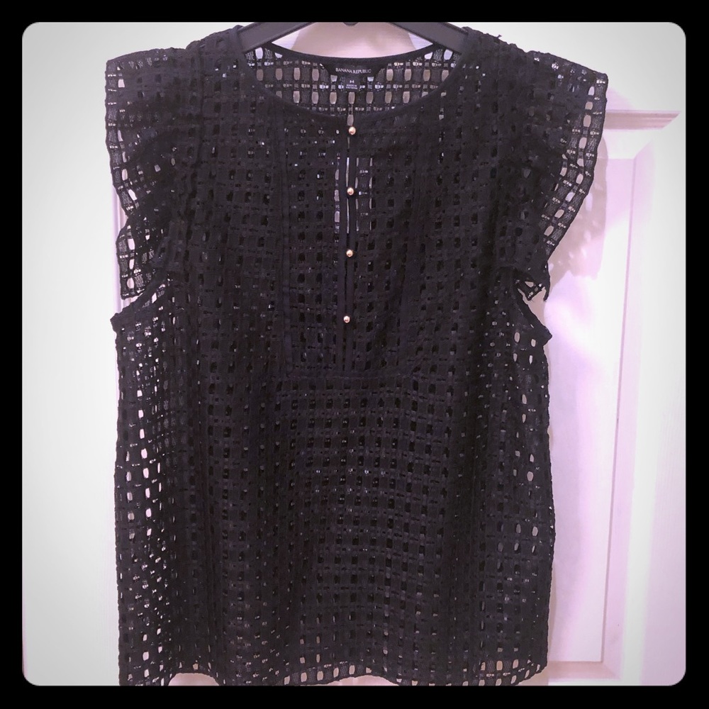 Black sleeveless top with gold buttons